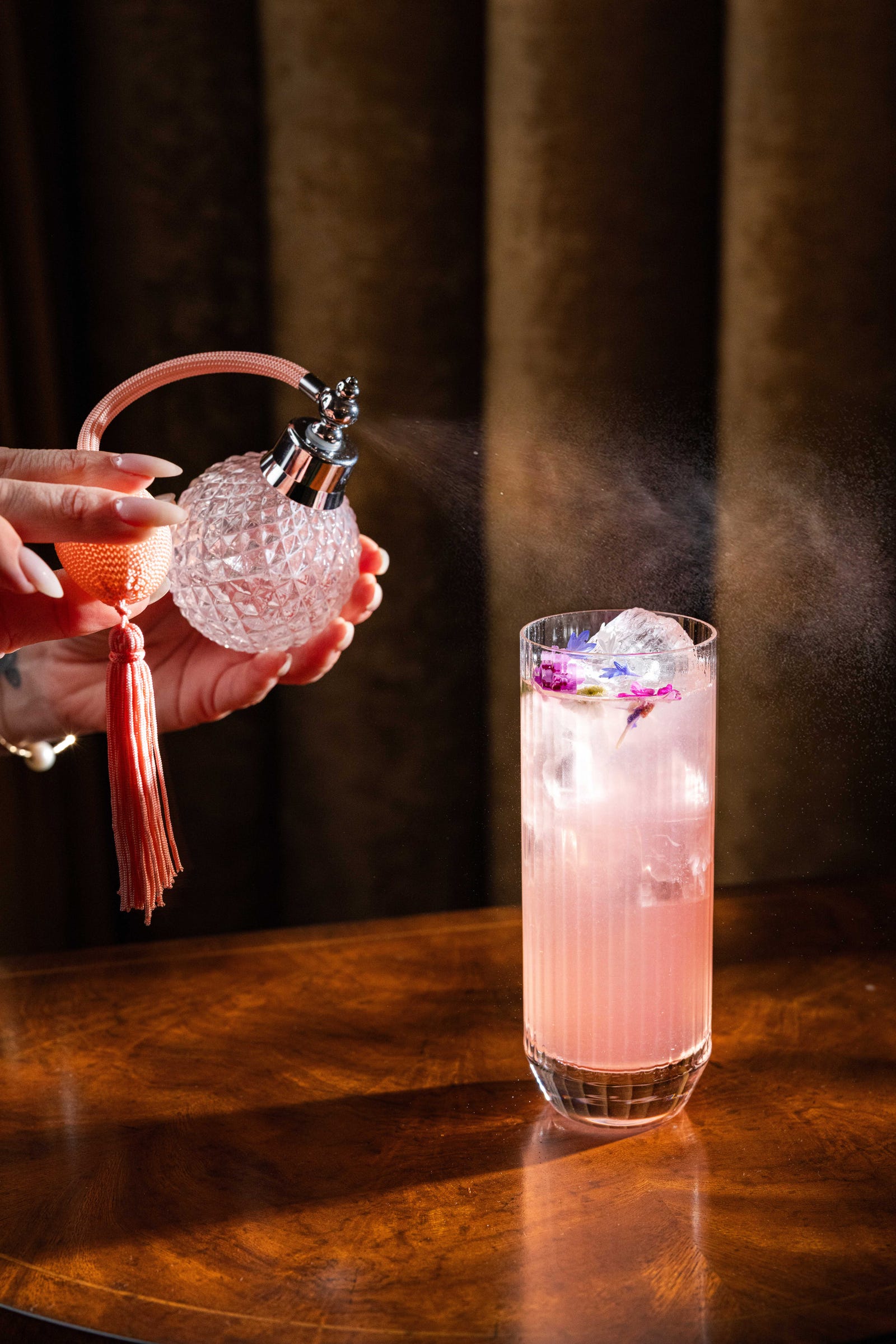 Cocktail being prepared at Delilah Dallas with a vintage atomizer