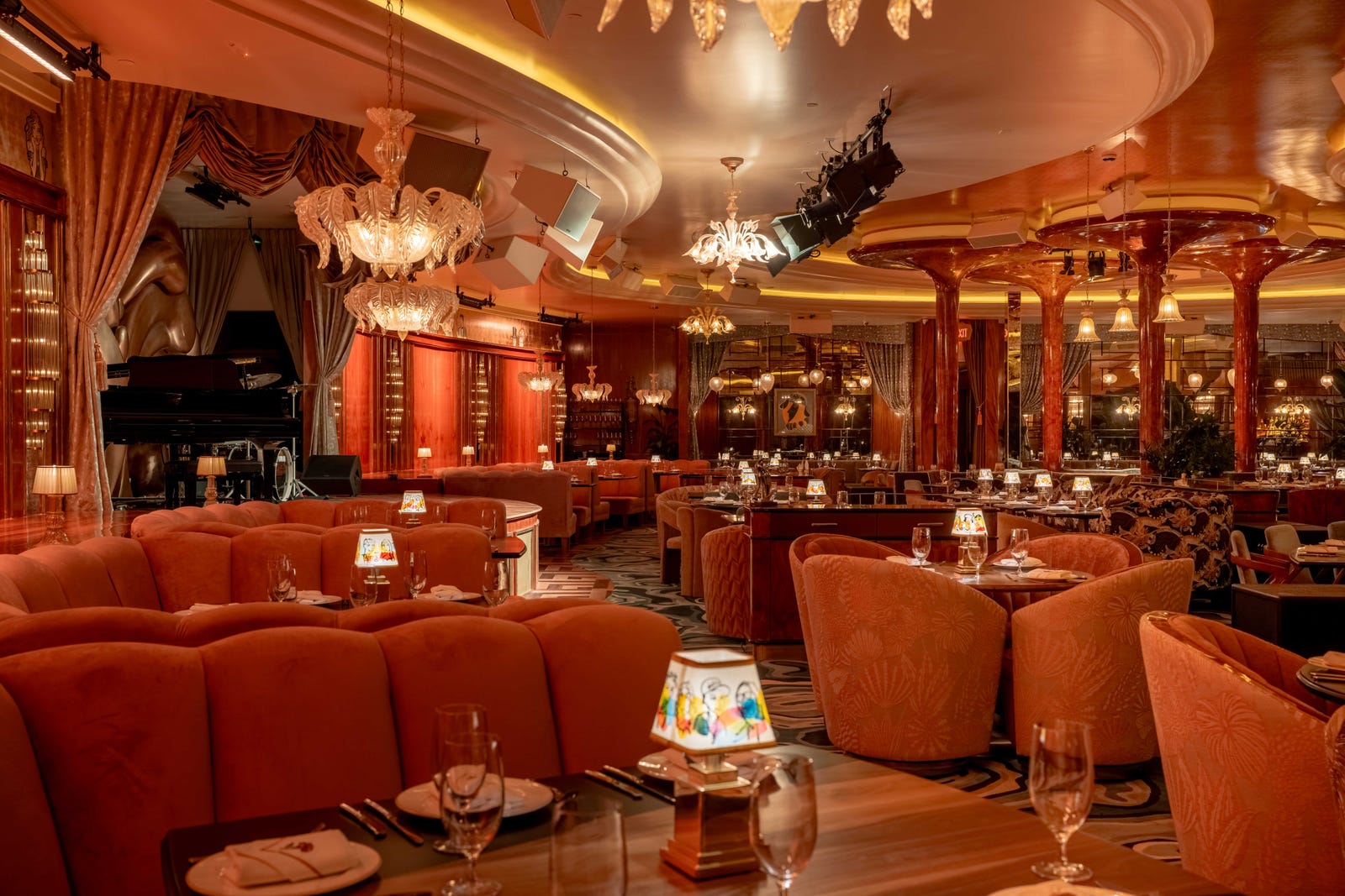 Elegant Delilah Dallas dining room with plush seating and a performance stage