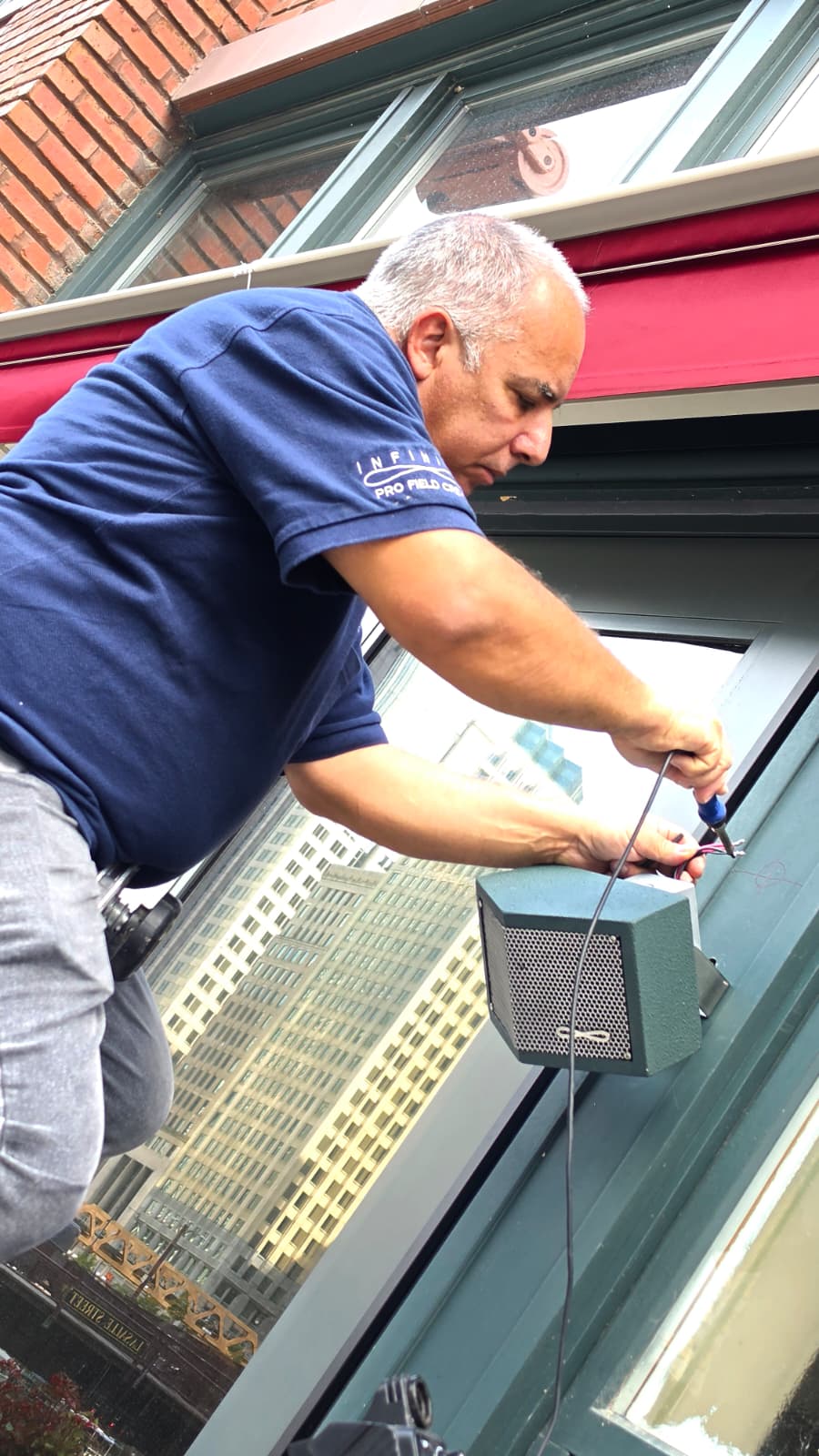 Infinite technician installing a loudspeaker